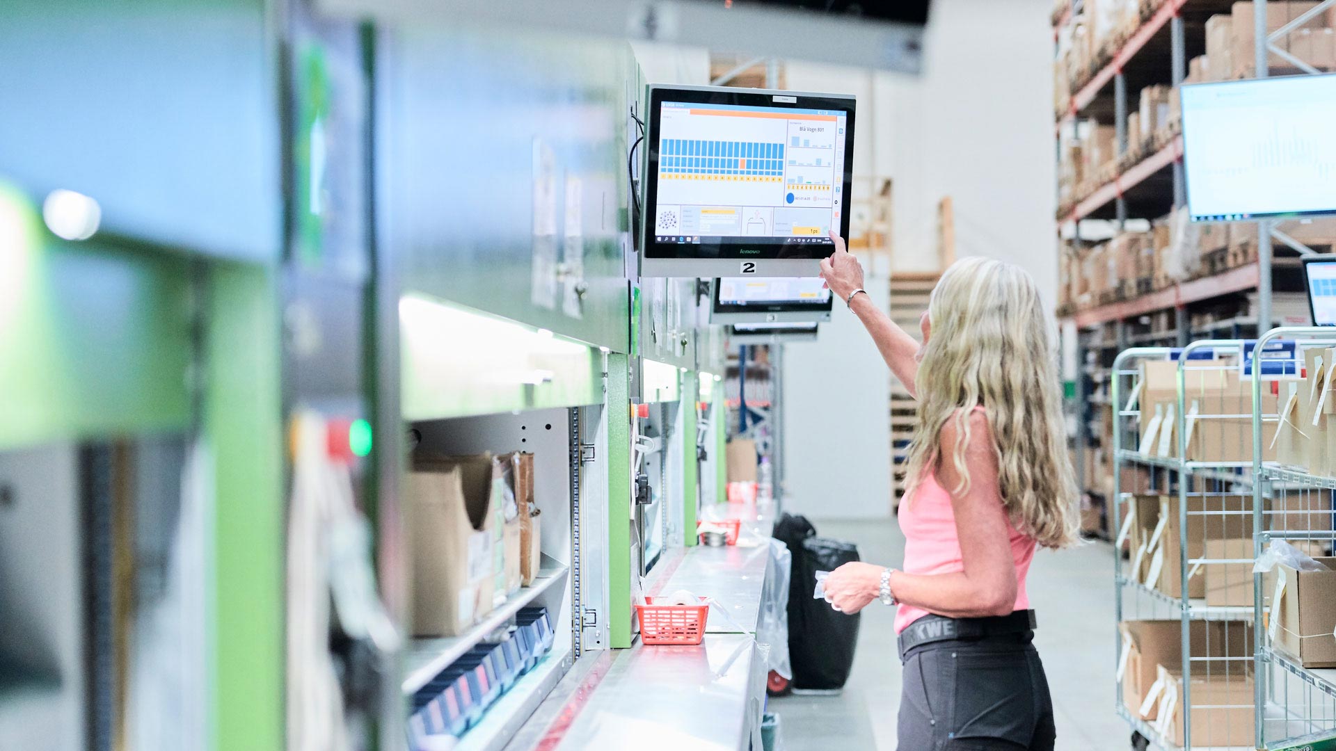 En medarbejder anvender en lagerautomat med LOGIA WMS.