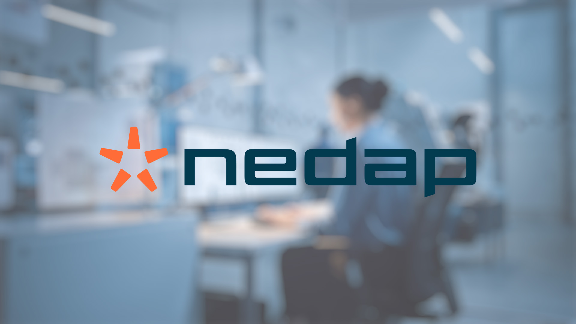 Blurred office background with a focus on the "Nedap" logo and orange star emblem in the foreground, conveying a modern tech environment.