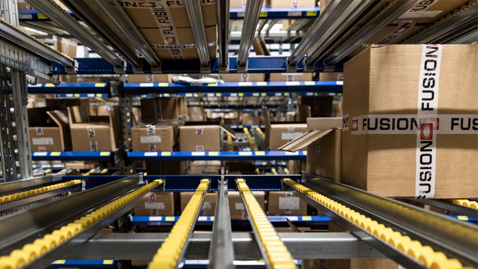 Fusion's picking area features neatly organized boxes filled with various products, ready for selection and processing.