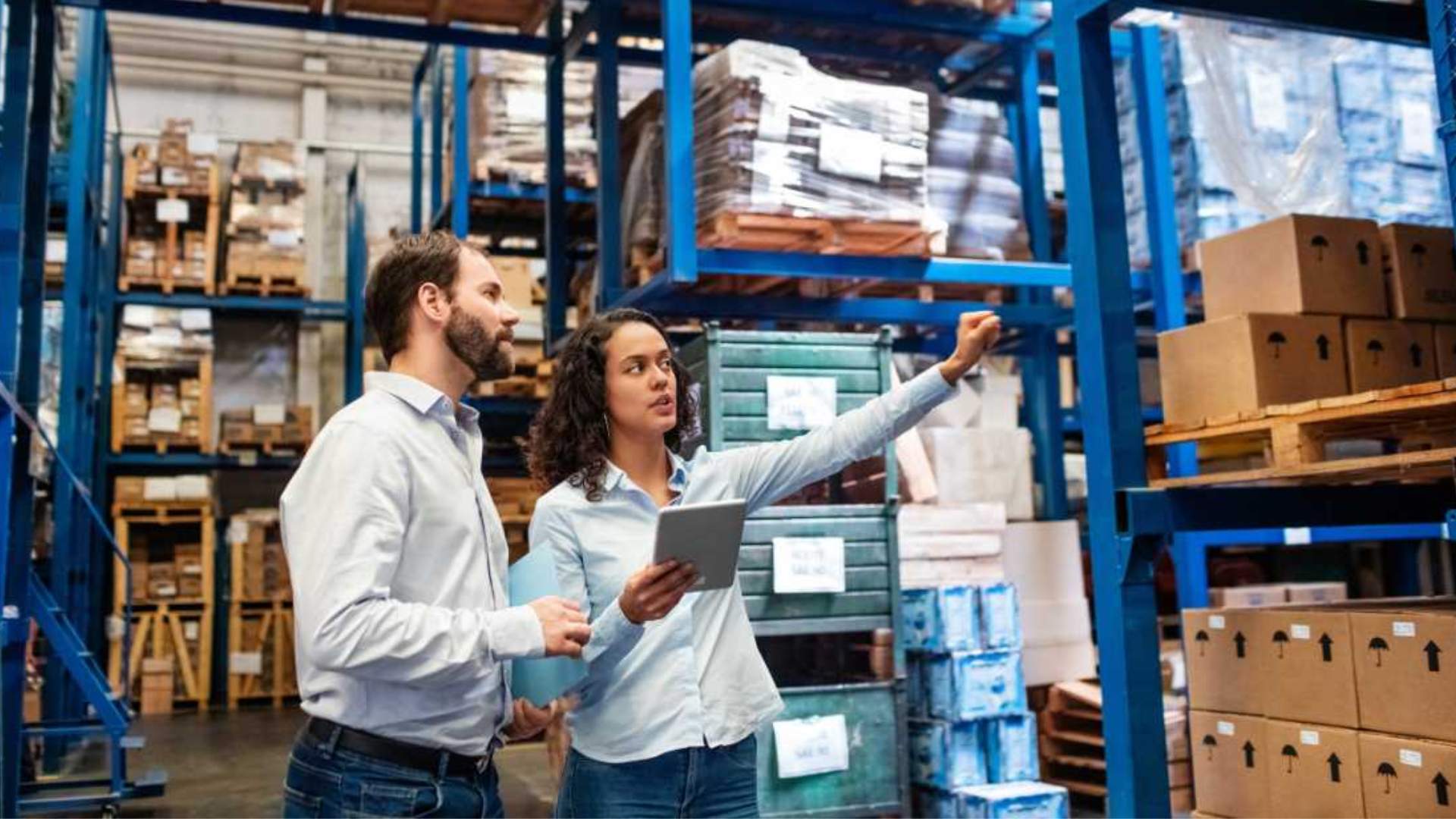 Two people with a tablet in a warehouse.