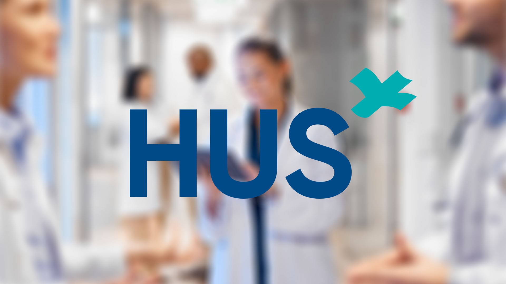Blurred image of medical professionals in a hospital corridor with the logo "HUS".