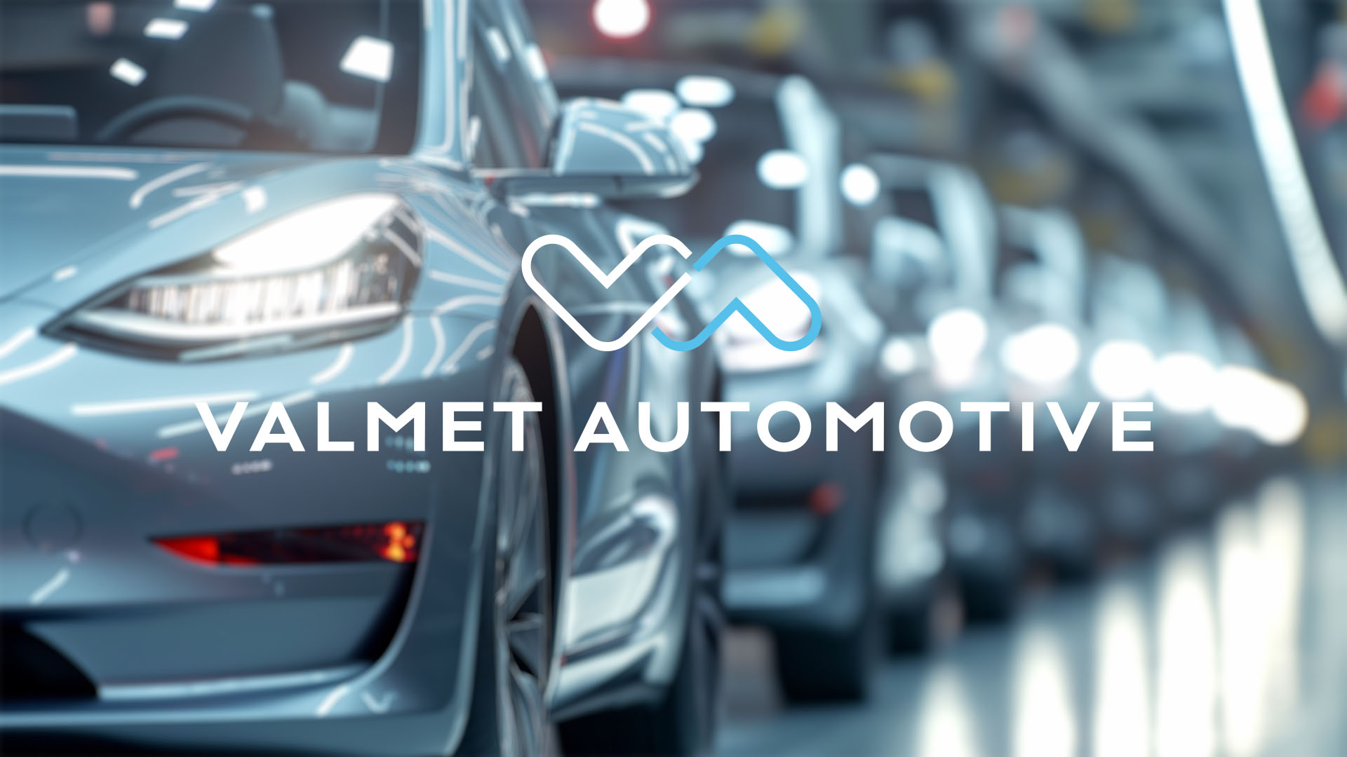 Close-up of a sleek blue car headlight on a production line. "Valmet Automotive" logo is centered, evoking innovation and precision.
