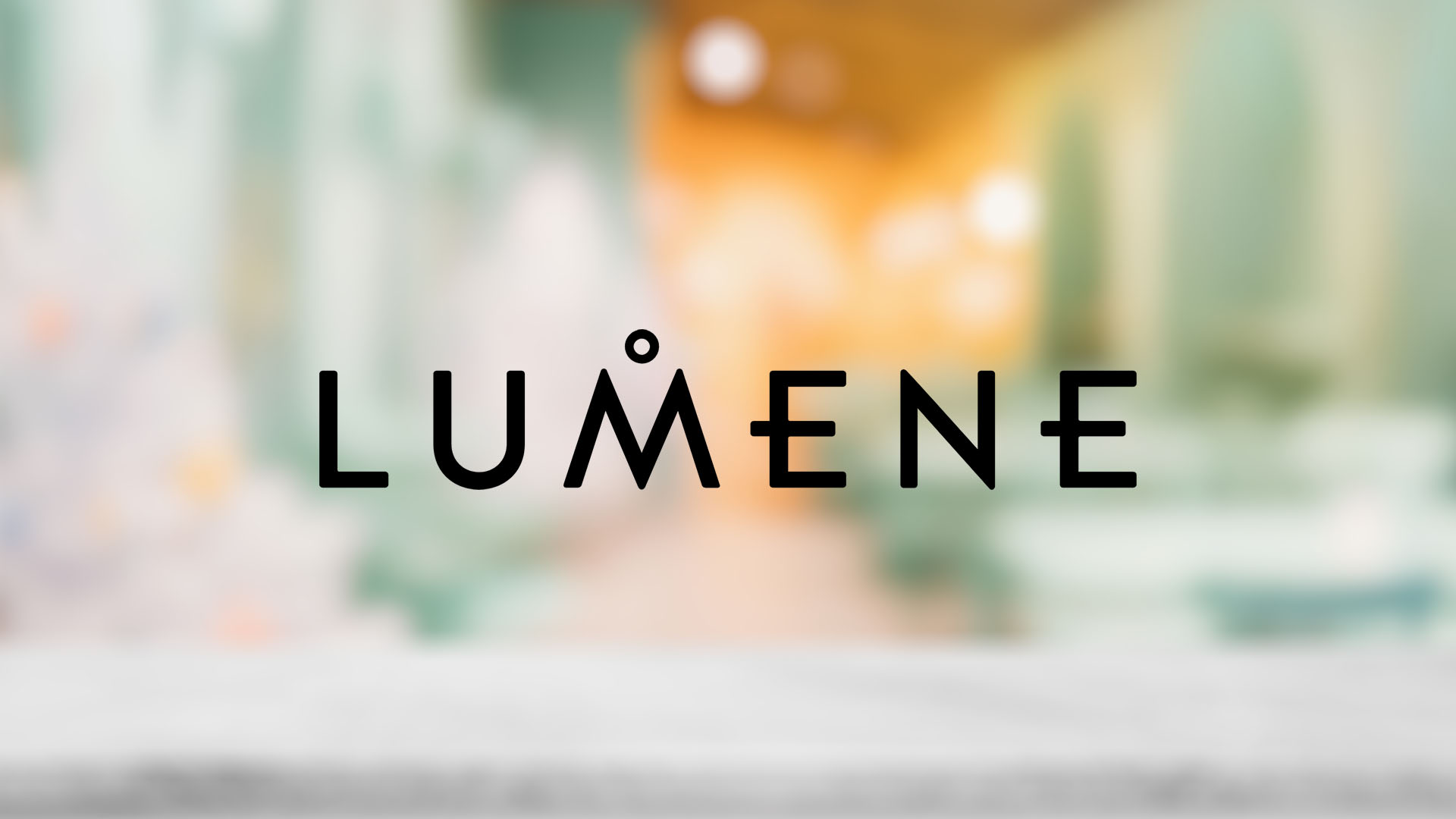 The logo "LUMENE" in bold, black letters is centered against a blurred background with warm, soft green and orange hues, creating a calm tone.