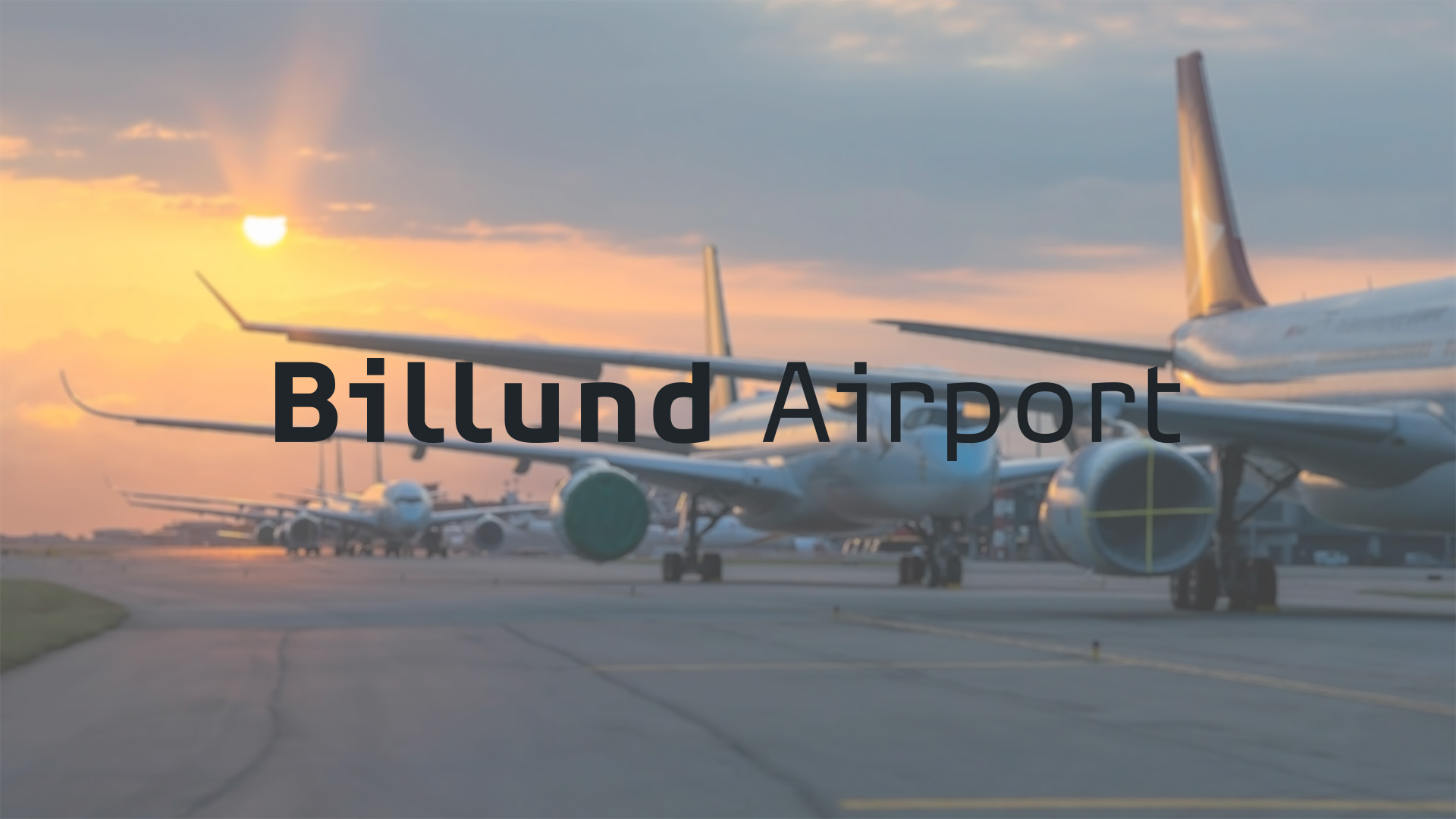 Sunset view of several airplanes on the tarmac at Billund Airport. Warm orange and yellow hues enhance a serene, bustling travel scene.