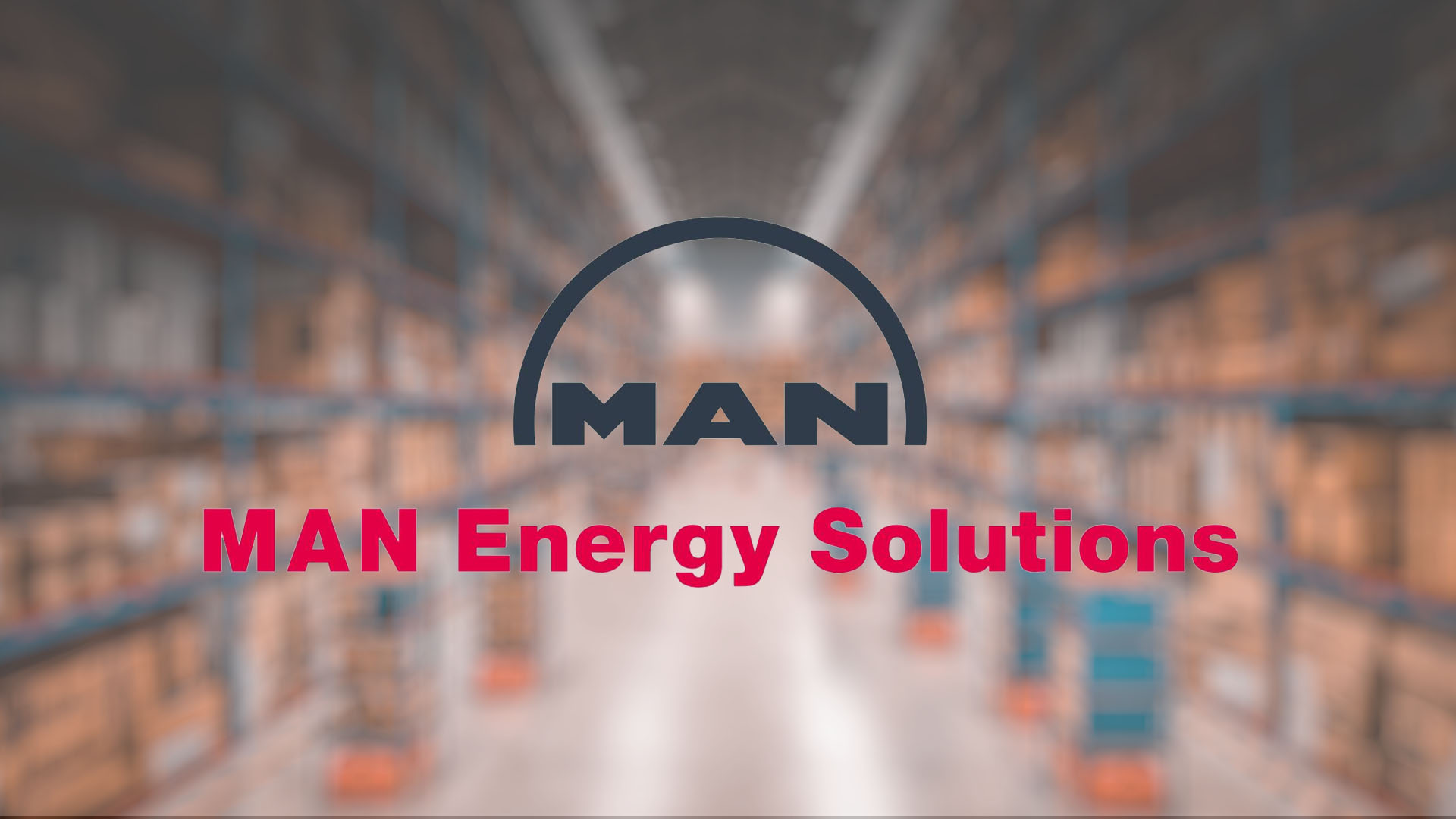 Blurred warehouse shelves filled with boxes create the backdrop for the logo of "MAN Energy Solutions" in bold text, conveying an industrial tone.
